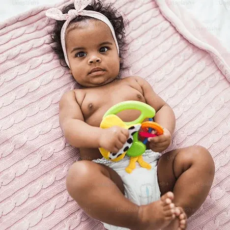 Baby on pink blanket